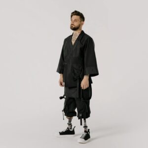 A powerful portrait of a tattooed man with prosthetic legs, capturing strength and style.